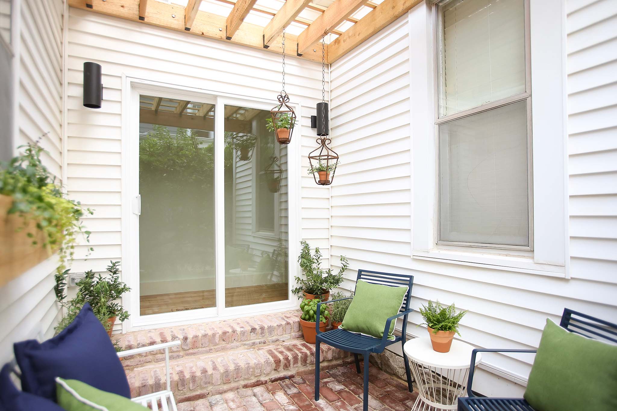 French Doors lead to a cozy porch with custom built pergola.