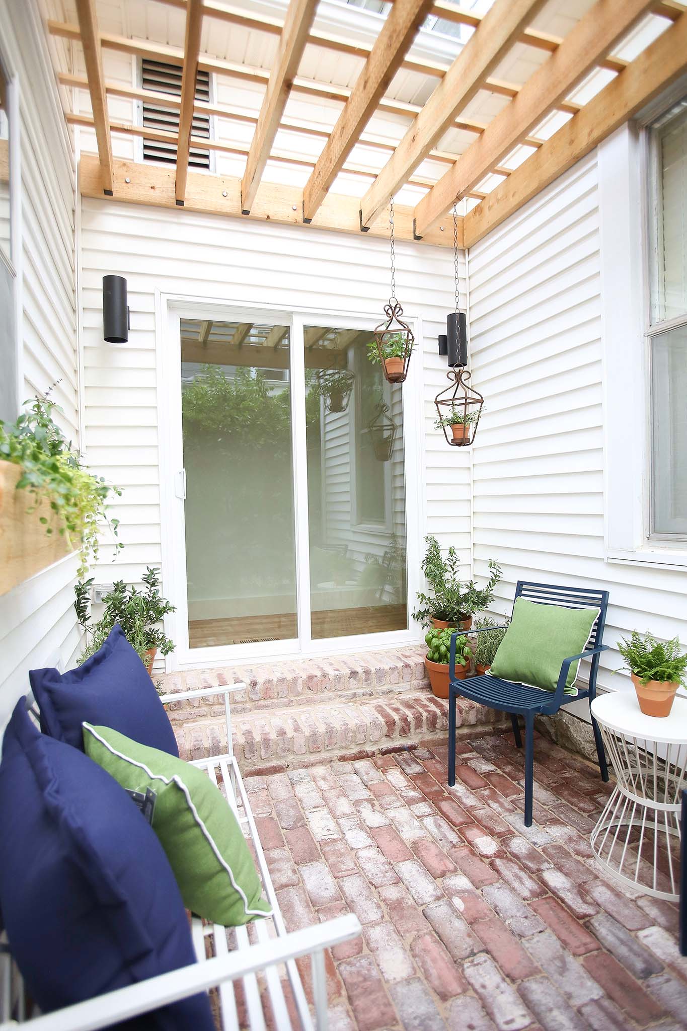 French Doors lead to a cozy porch with custom built pergola.