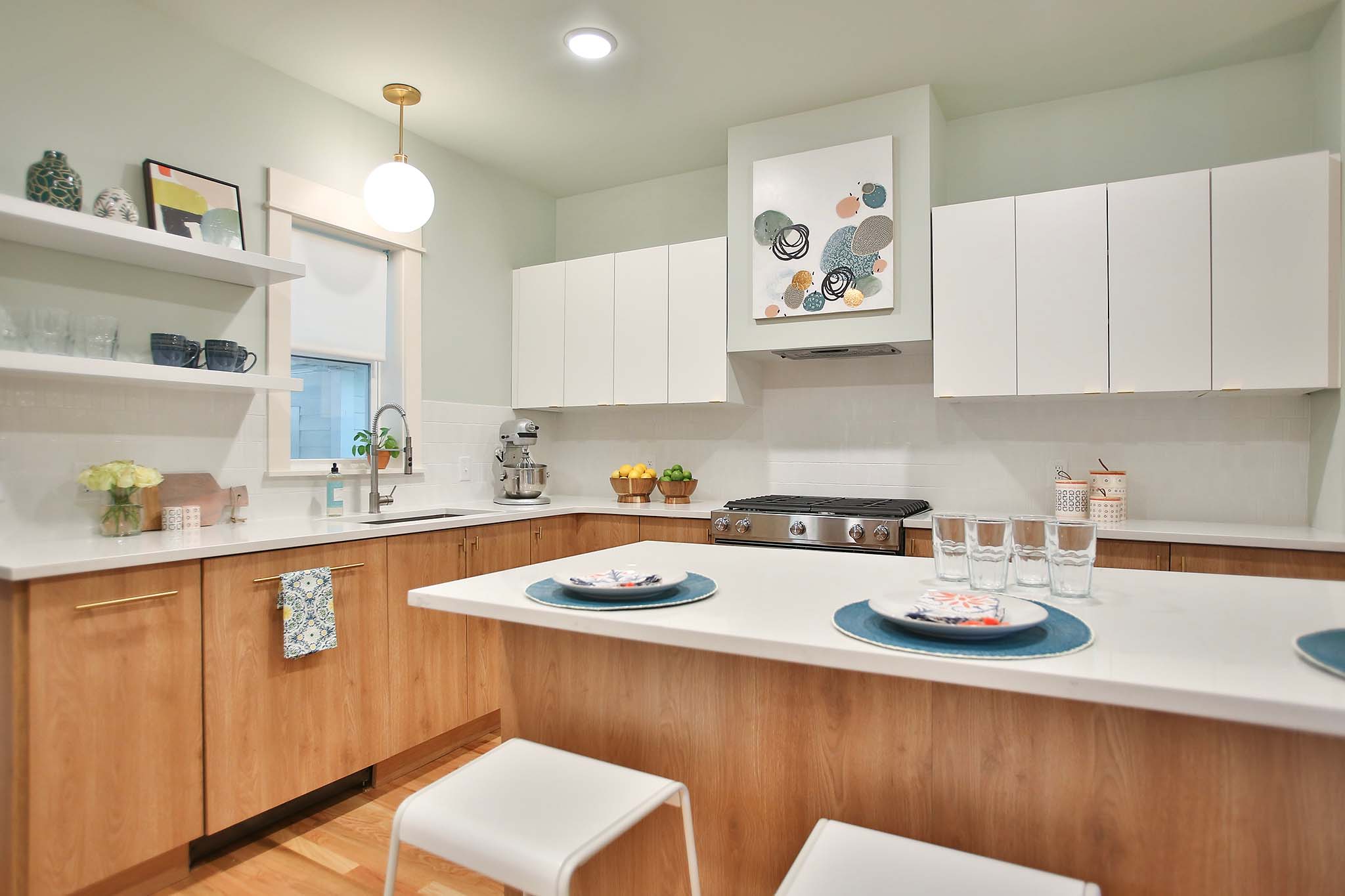 Modern and mid century kitchen using white laminate cabinets and white counter tops.
