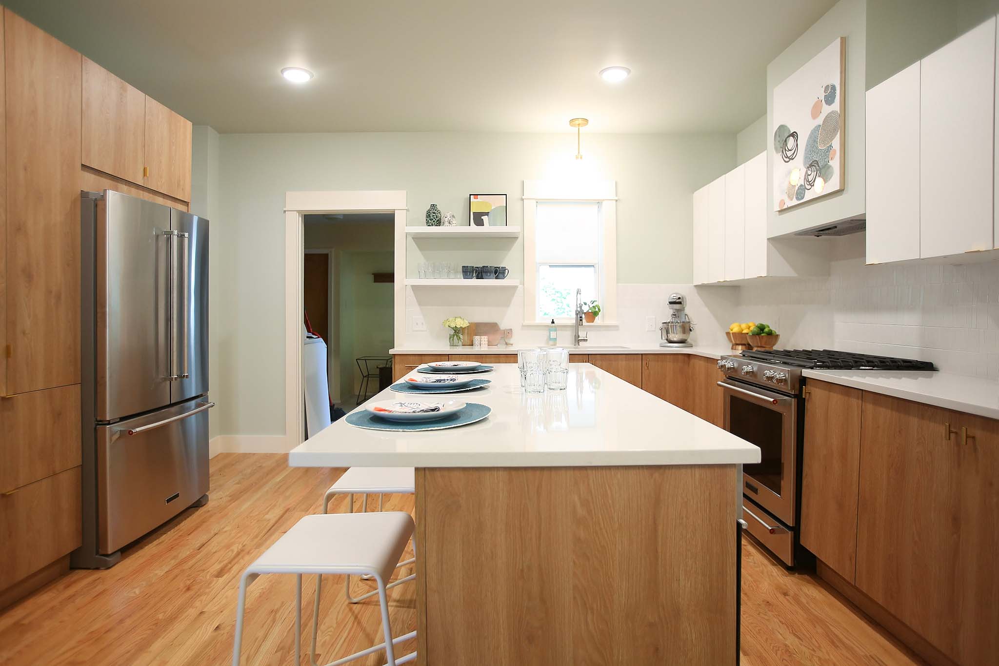 Modern and mid century kitchen using white laminate cabinets and white counter tops.