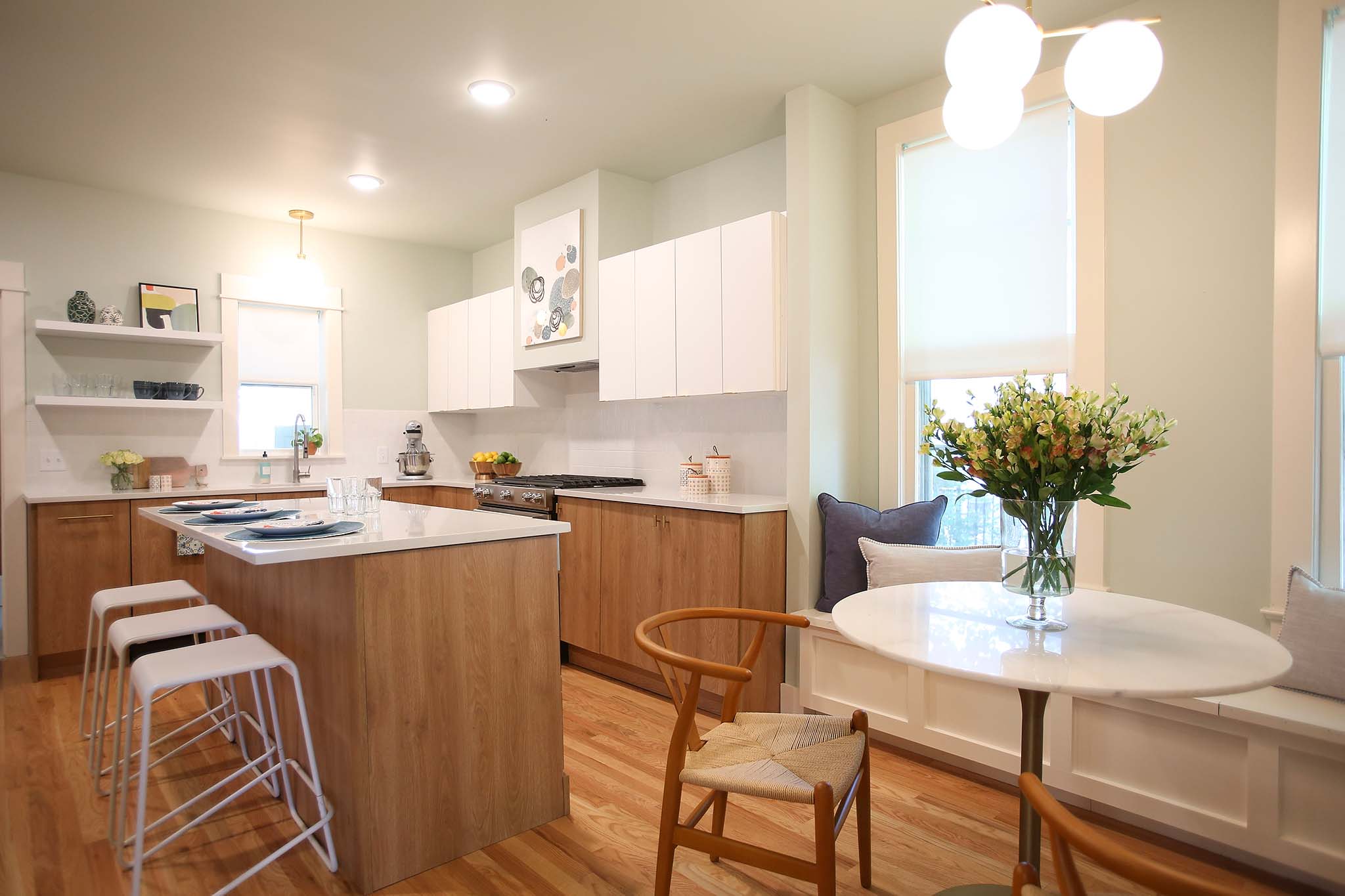 Modern and mid century kitchen using white laminate cabinets and white counter tops.