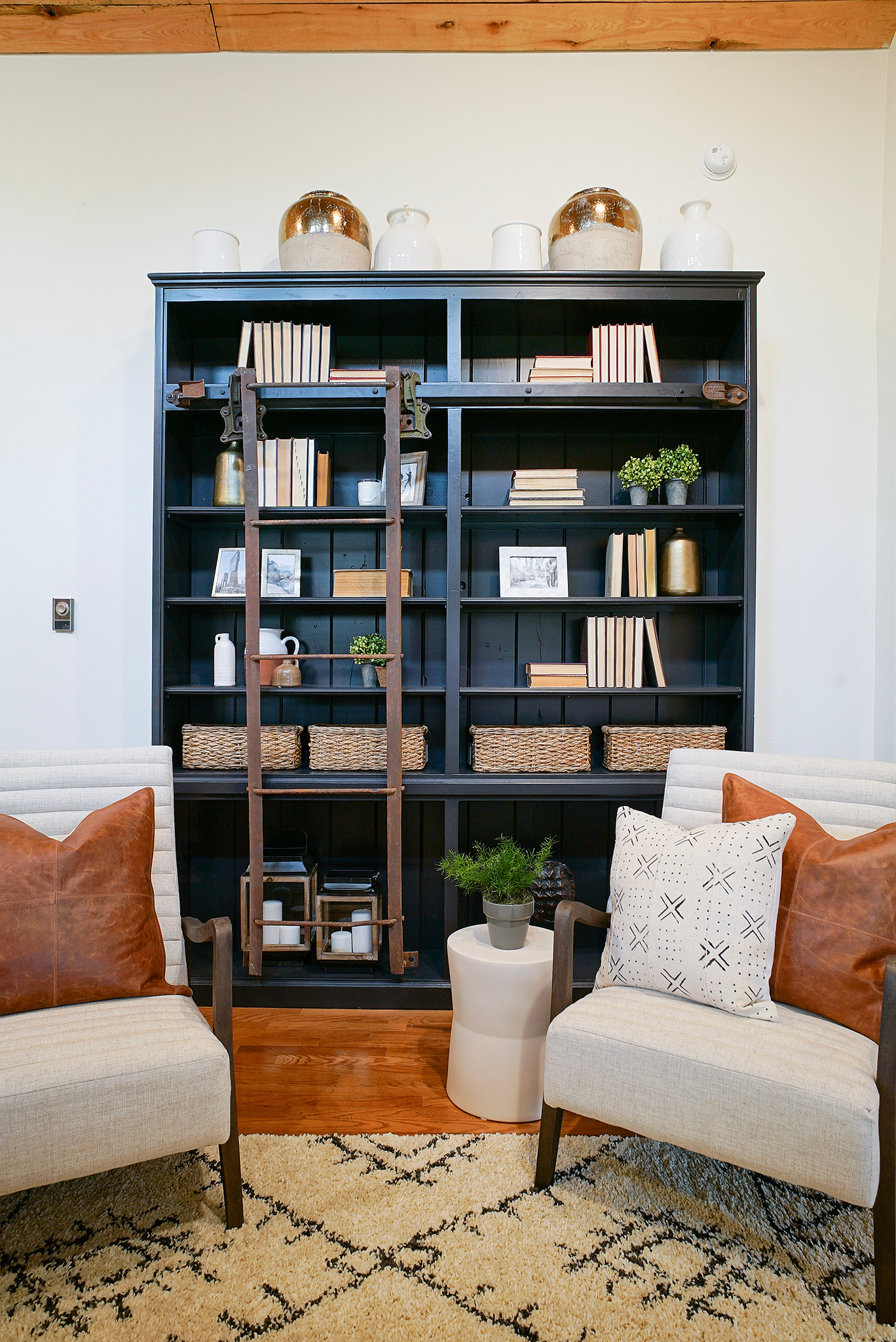 A colorful custom built book shelf - with an antique ladder and door rollers that Dave salvaged off of an old railroad boxcar.
