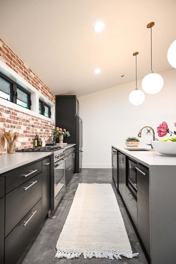 HGTV Fixer to Fabulous Kitchen Renovation with brick backsplash and large kitchen island.