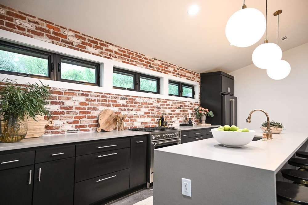 HGTV Fixer to Fabulous Kitchen Renovation with brick backsplash and large kitchen island.