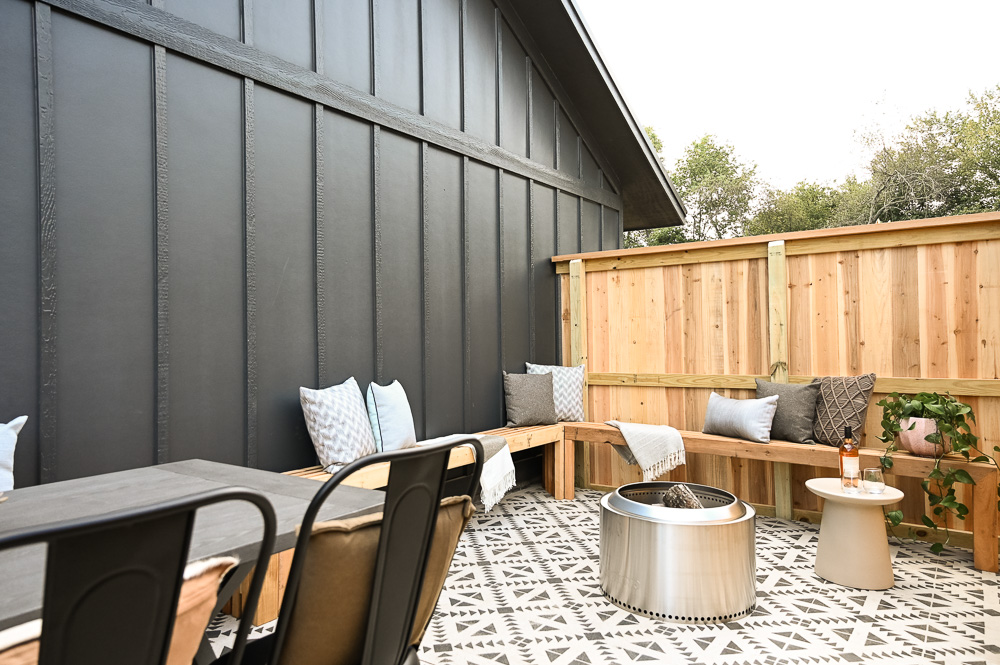 HGTV Fixer to Fabulous Patio Renovation with L-shaped bench and painted concrete.