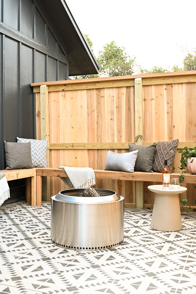 HGTV Fixer to Fabulous Patio Renovation with L-shaped bench and painted concrete.