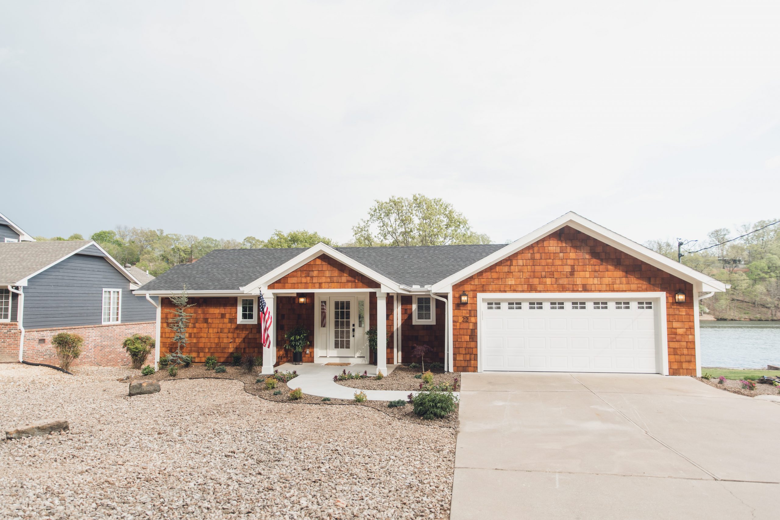 HGTV Fixer to Fabulous Season 2. Exterior lake house view with shake siding.