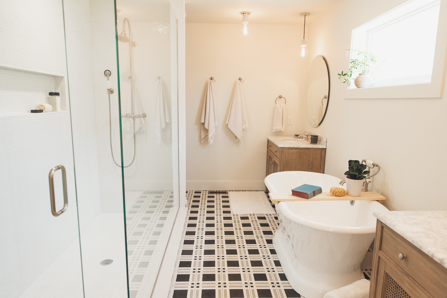 HGTV Fixer to Fabulous Lake House Bathroom with free standing tub and patterned tile floor.