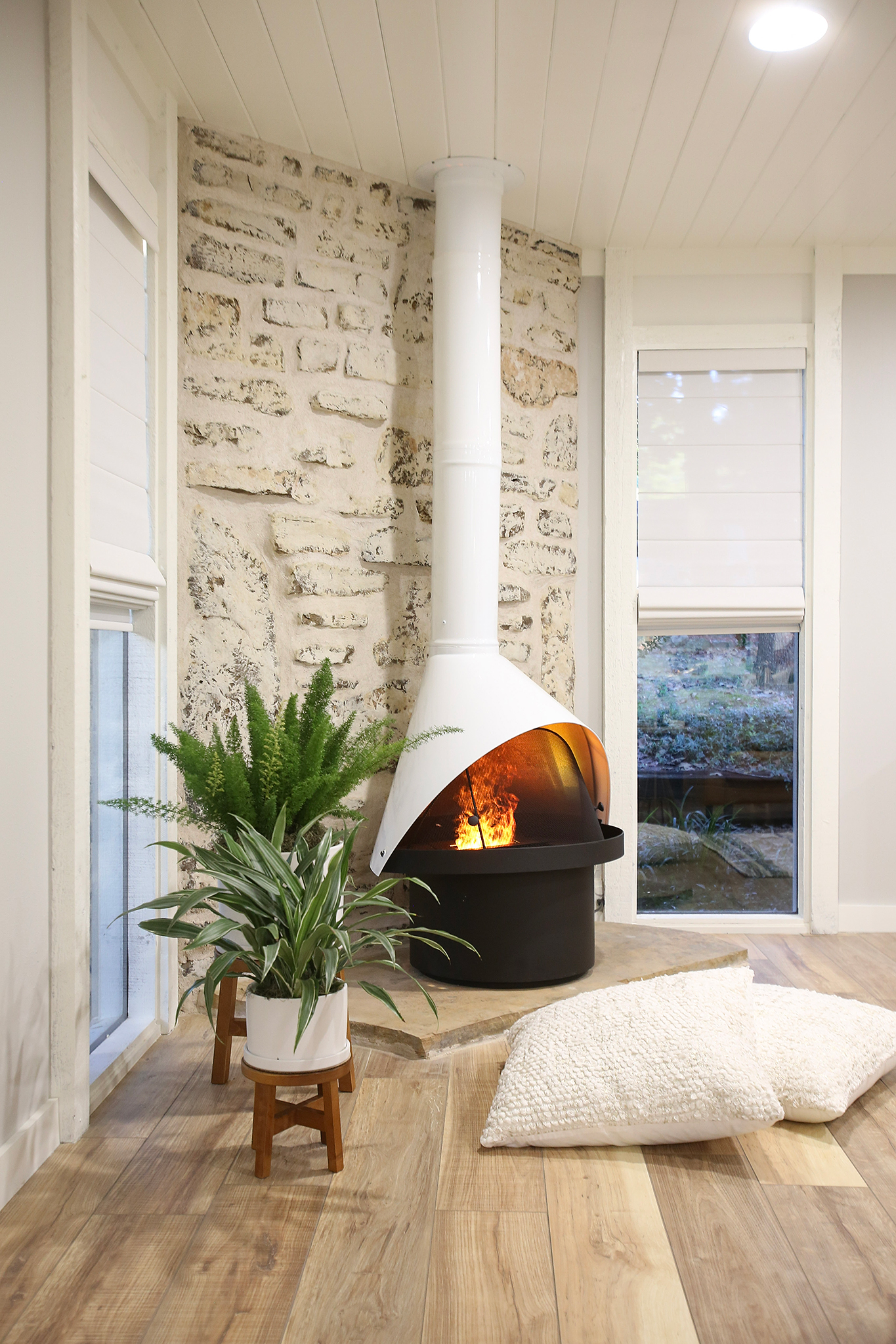 Living room renovation with fireplace and painted rock on HGTV Fixer to Fabulous.