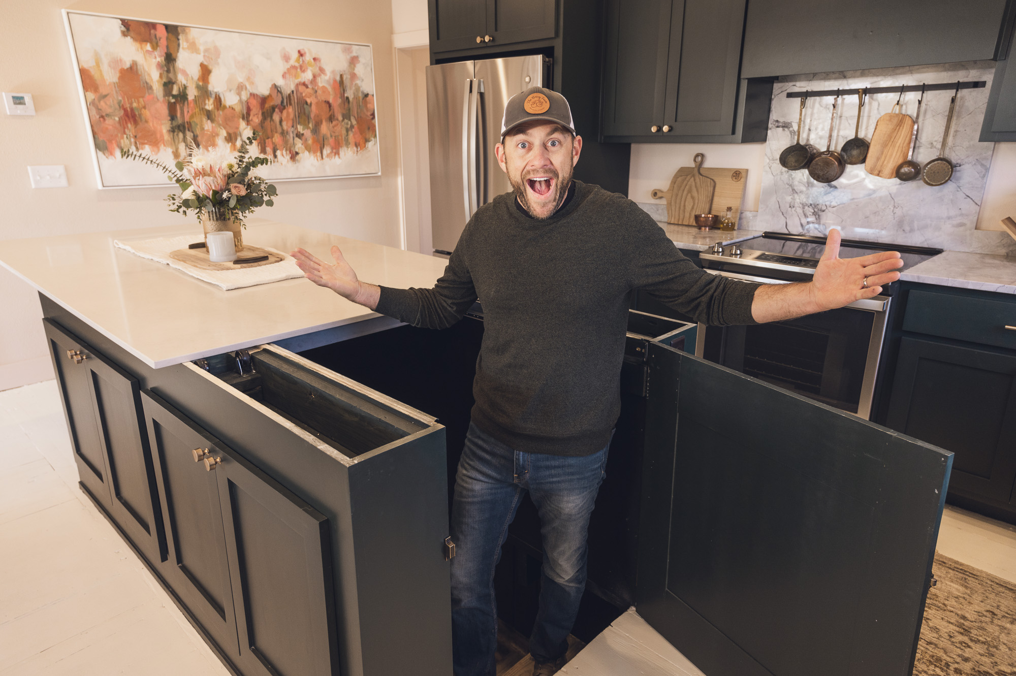 Dave Marrs revealing cellar space with pushed-back kitchen island