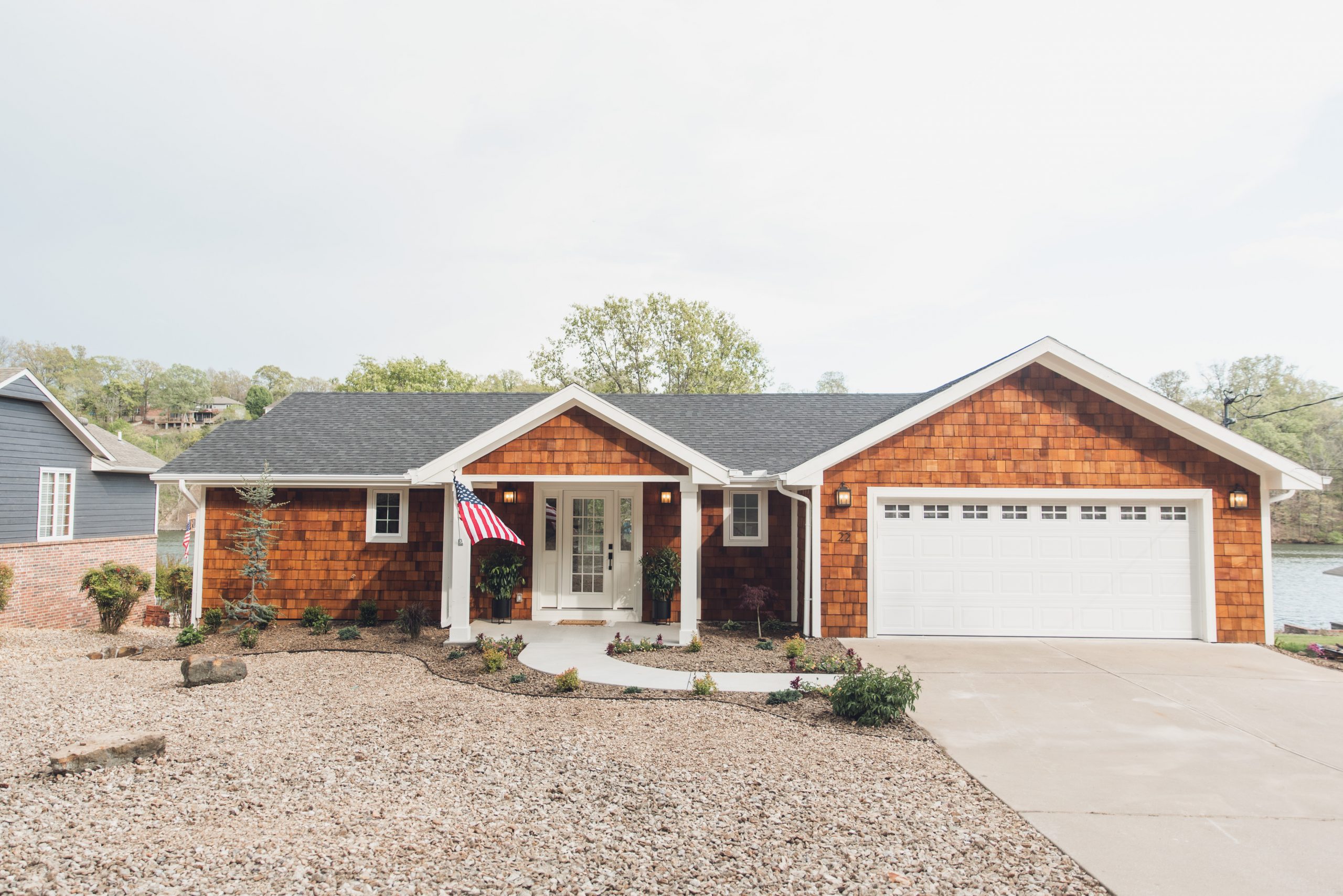 HGTV Fixer to Fabulous Season 2. Exterior lake house view with shake siding.
