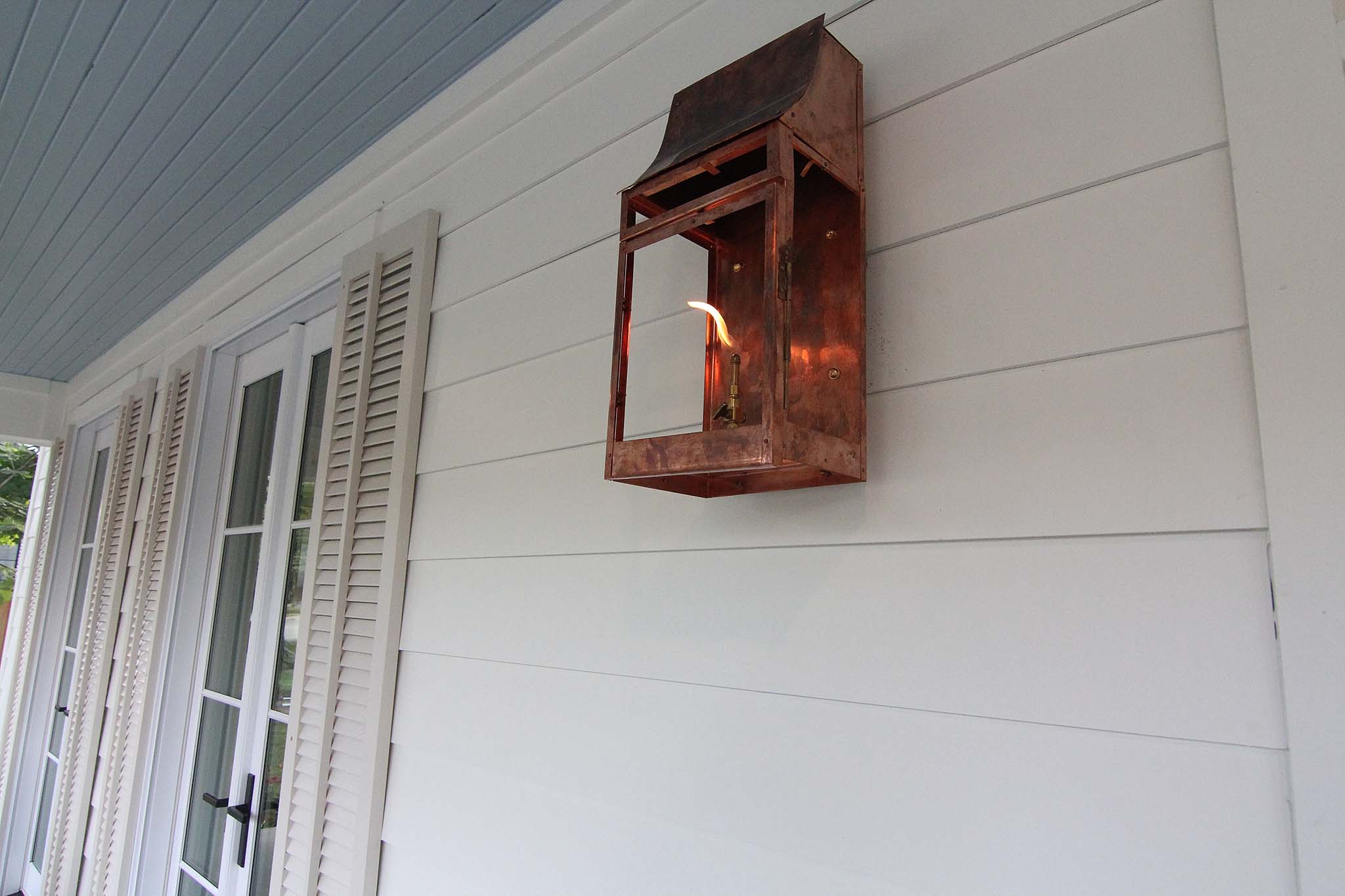 Custom copper gas lanterns perfect for this Creole front porch.