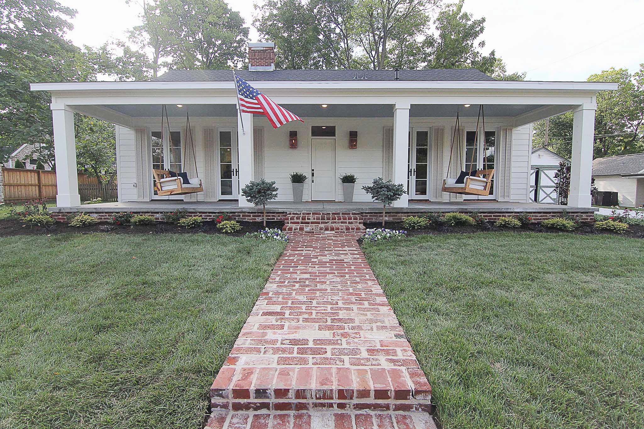 Front porch renovation with dual custom built porch swings on HGTV Fixer to Fabulous.