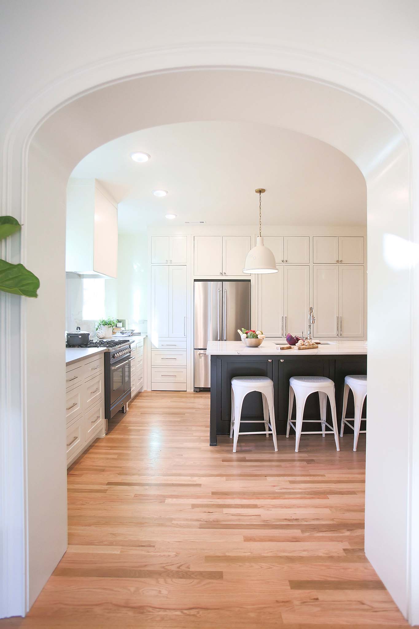 Archway leading into brand new kitchen on HGTV Fixer to Fabulous.