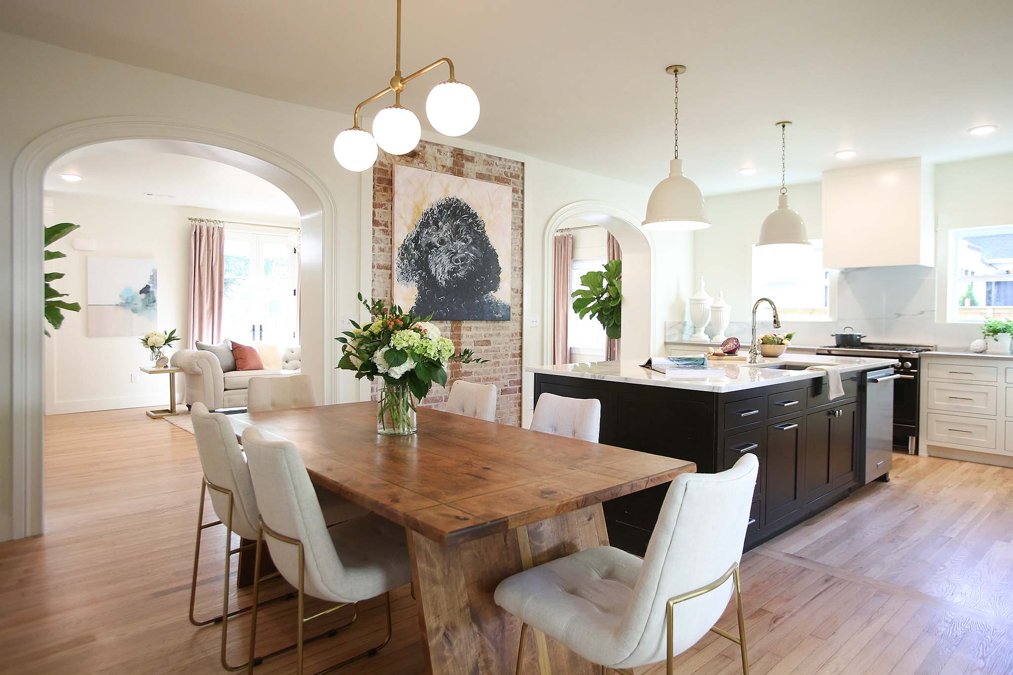 Kitchen and Dining renovation with exposed brick and large archways.