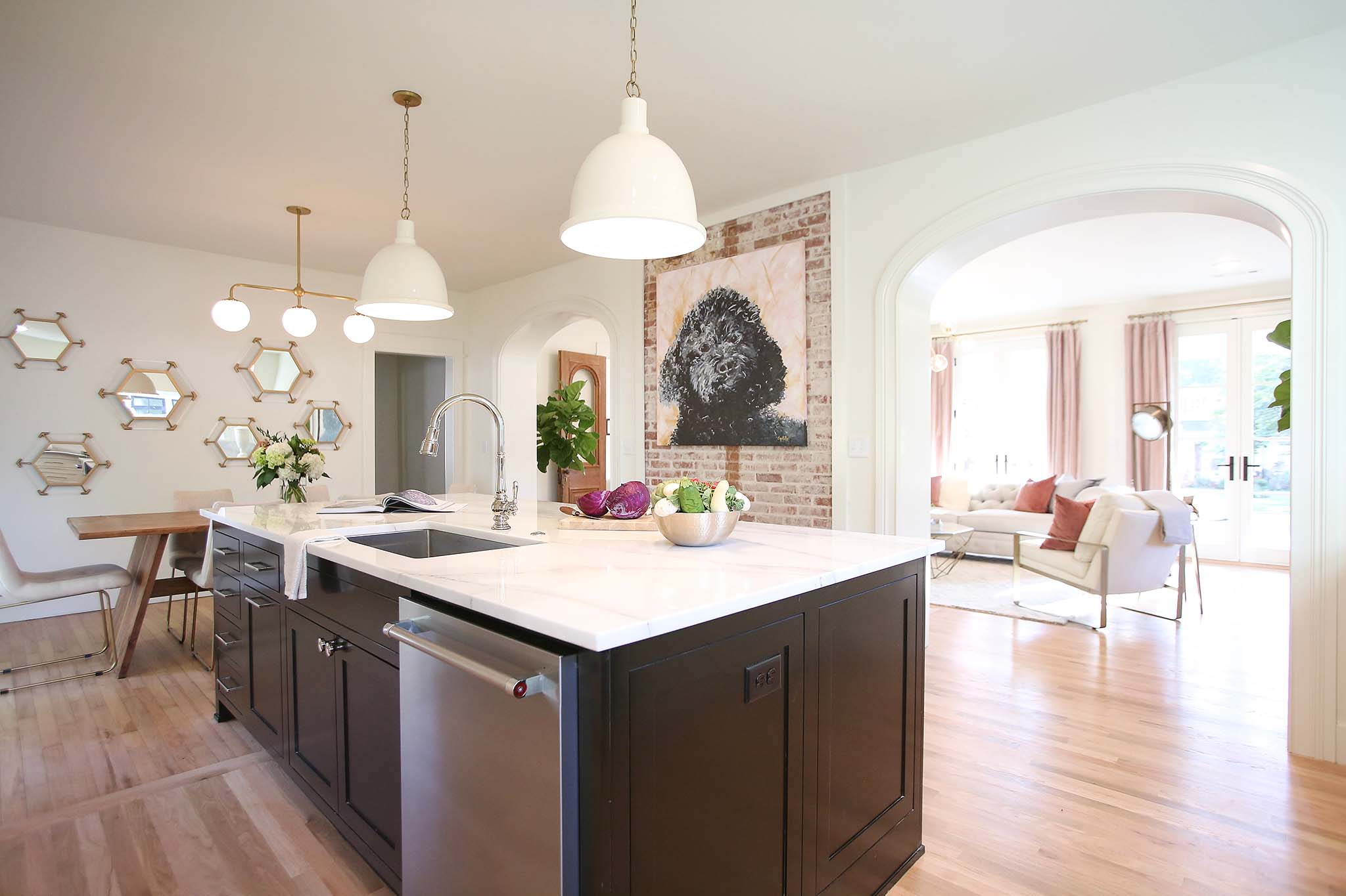 Kitchen renovation with large kitchen island and beautiful pendent lights.