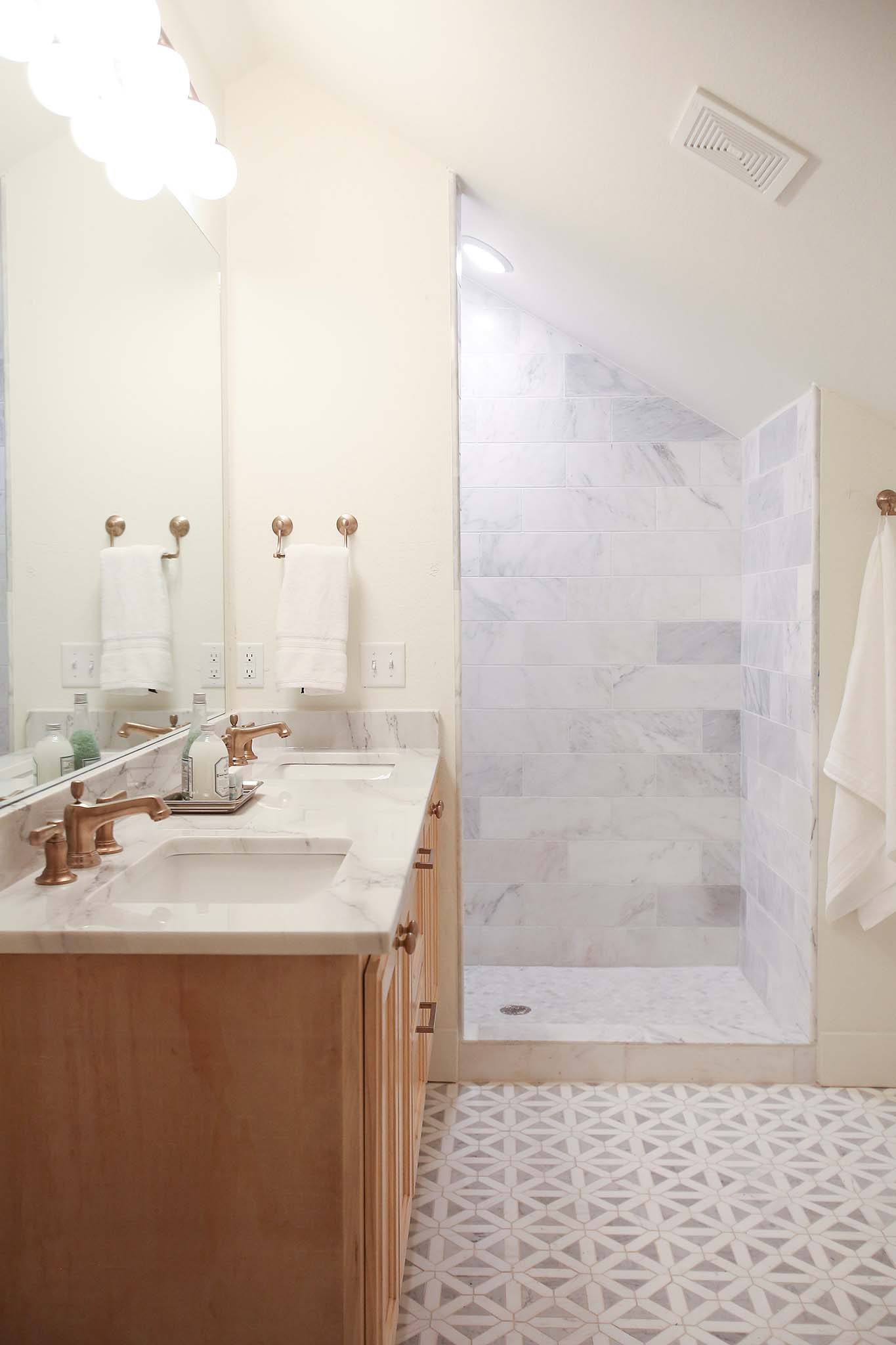 Custom shower and double vanity in this bathroom renovation on HGTV Fixer to Fabulous.