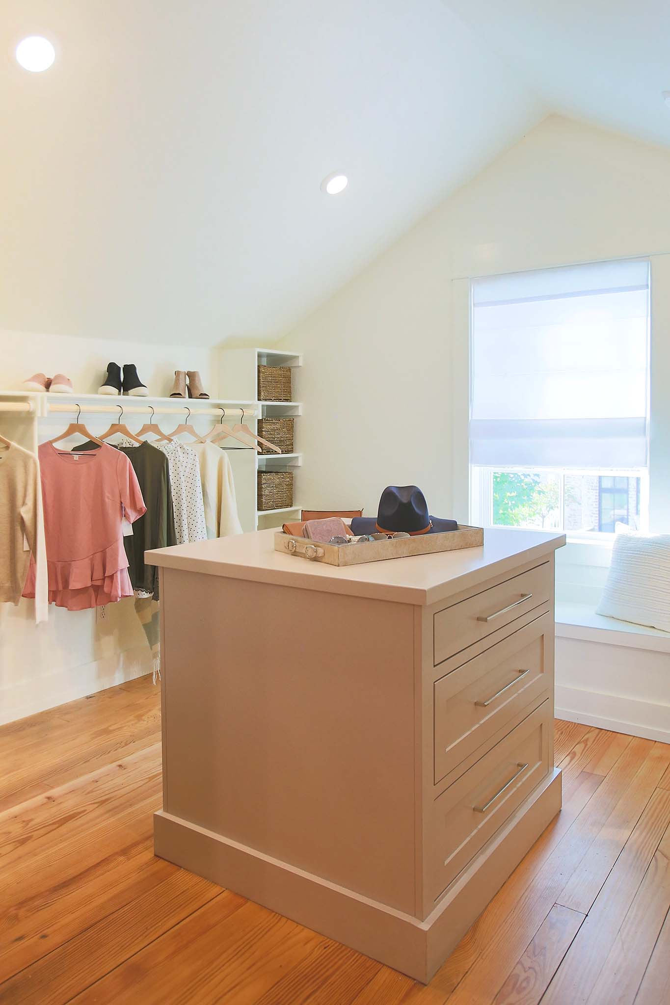 Custom built dresser island in walk in closet.