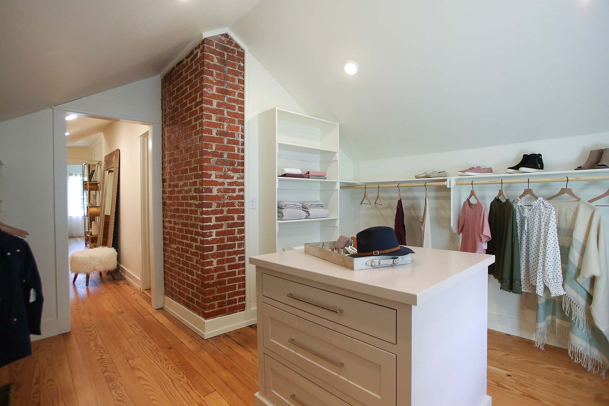 Custom walk in closet with dresser island on HGTV Fixer to Fabulous.