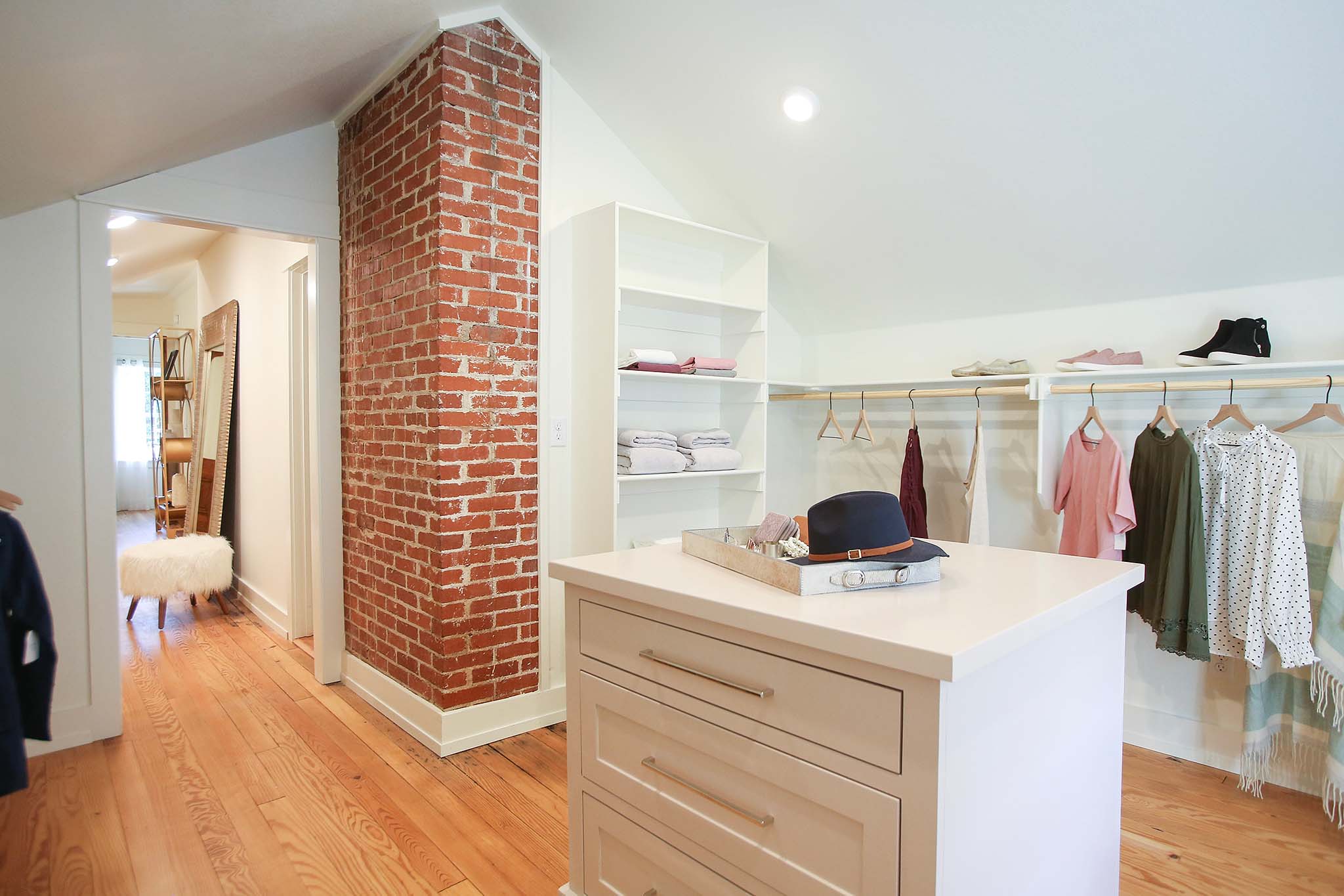 Custom walk in closet with dresser island.